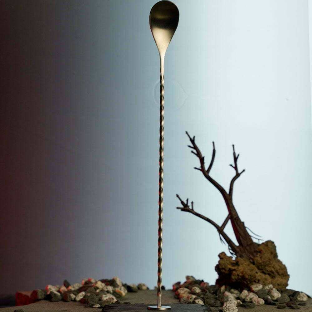 Stainless steel bar spoon with a layering side