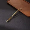 Ridged Handle Gold Tweezer laying on a brown object