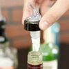 30 ml Measured Liquid Pourer Being Placed Into Bottle