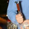 Bartender shaving an ice cube with the Anvil Head Ice Pick