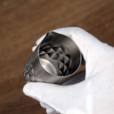 Diamond Spouted Single Jigger Silver Variant Held by a Hand wearing gloves