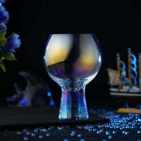 Empty Colorful Cocktail Glass around a dark blue background