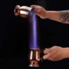 beverage set on fire being poured from and into the Thick Bottom Moscow Mule Copper Mug