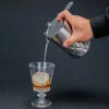 Double Walled Mixing Cup pouring liquid inside a shot glass