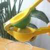 Double Trouble Fruit Squeezer about to squeeze a lemon inside a glass cup