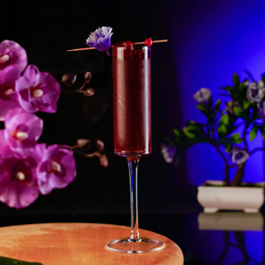 Edged Champagne Glass Filled with Red Cocktail