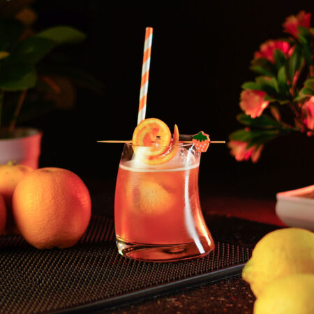 Orange cocktail San Salvador inside a short hunched glass