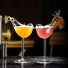 Wingless Bird Cocktail Glasses with orange and pink drinks, garnished with citrus, perfect for elegant presentations.