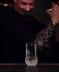 Bartender shaking a cocktail inside a Boston shaker