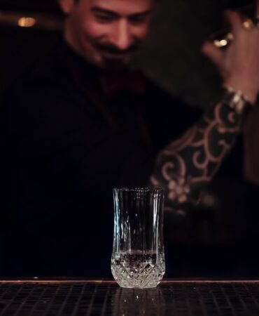 Bartender shaking a cocktail inside a Boston shaker
