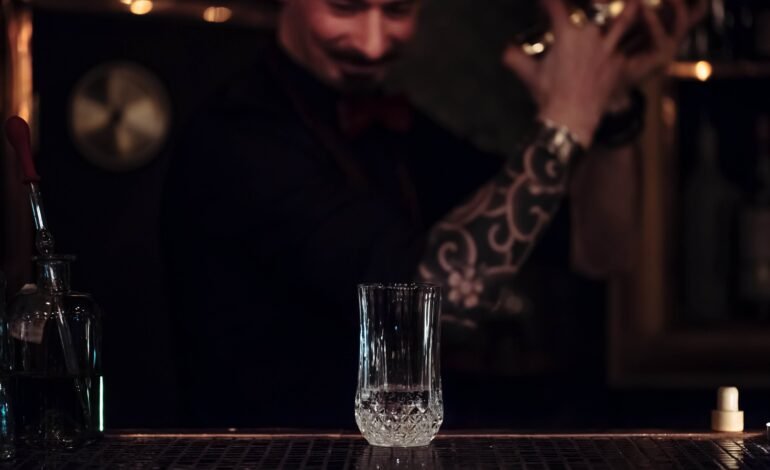 Bartender shaking a cocktail inside a Boston shaker