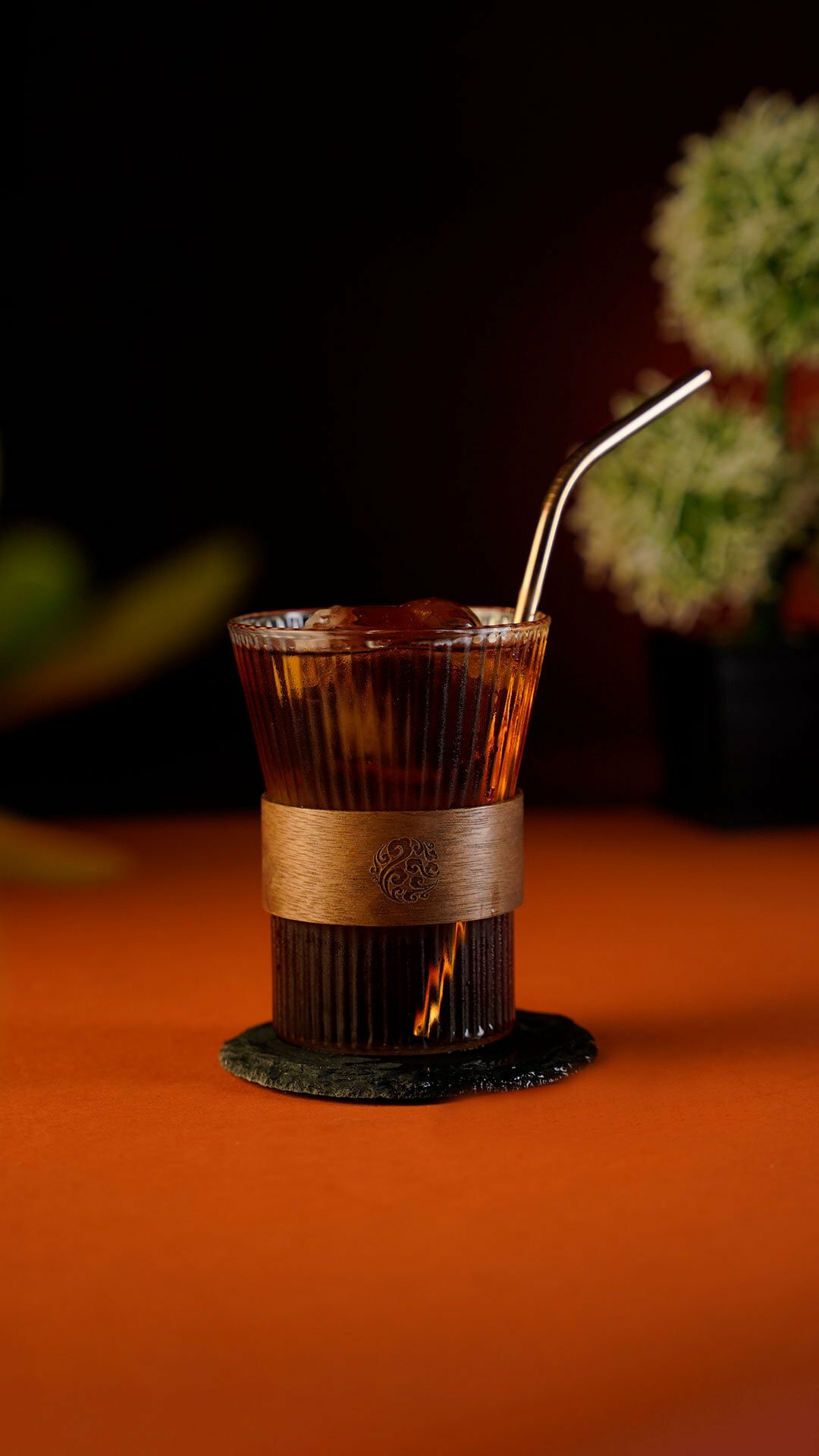 Dark coffee cocktail inside a striped tumbler glass