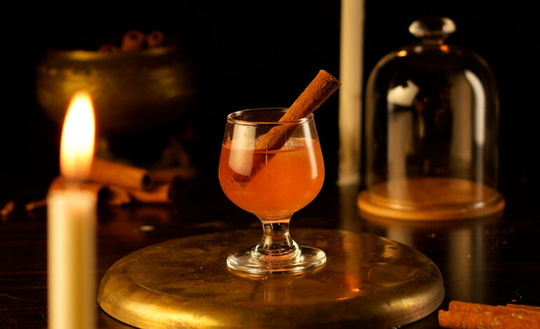 Smoked Cinnamon Whisky Cocktail served in a Snifter glass