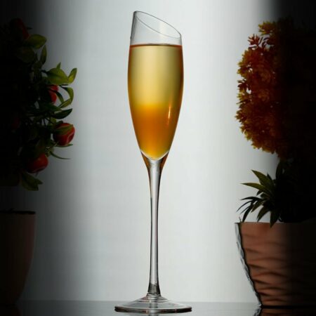 Orange Champagne cocktail inside a flute glass
