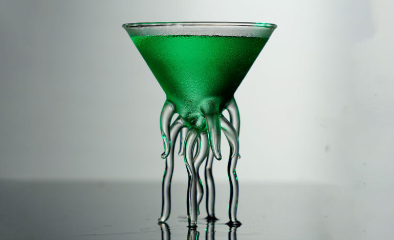 Green Cocktail inside a tiny martini glass with octopus legs