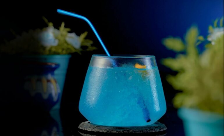 Short Exquisite Glass filled with a blue train cocktail