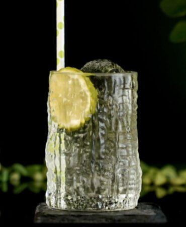 White Cocktail Inside a Highball Carved Glass