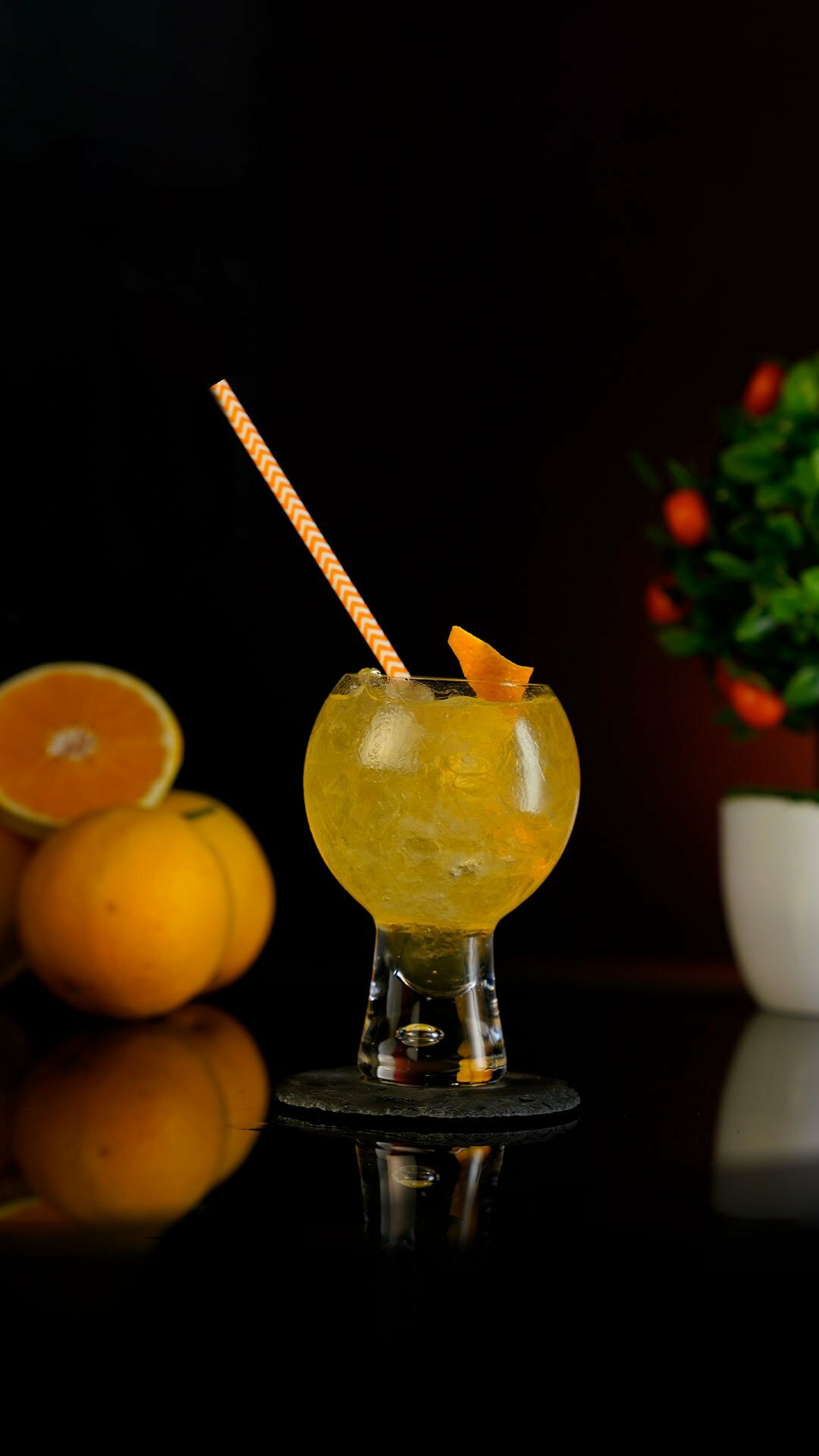 Orange Mixed Cocktail served in a rounded bubbly cocktail glass