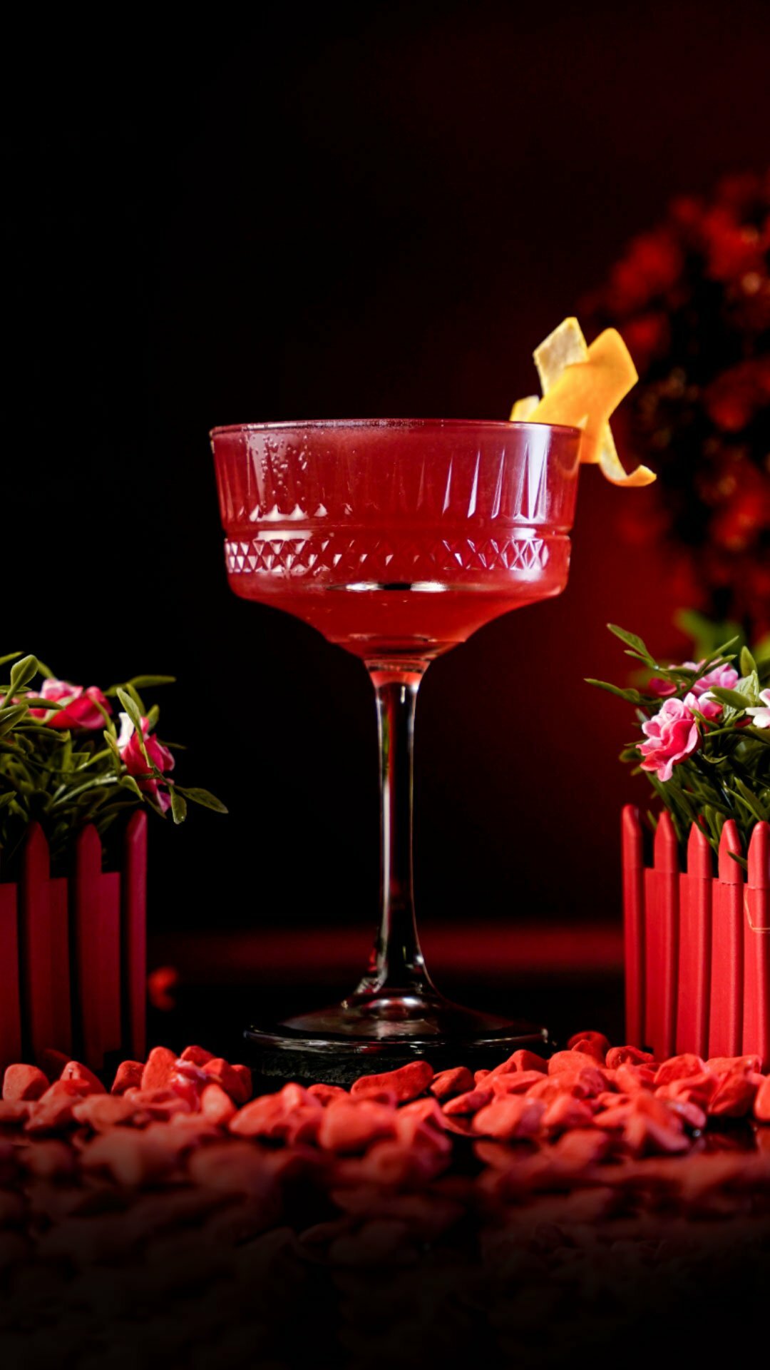 Red Cocktail Inside a Carved Coupe Cocktail Glass