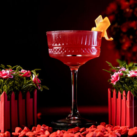 Red Cocktail Inside a Carved Coupe Cocktail Glass