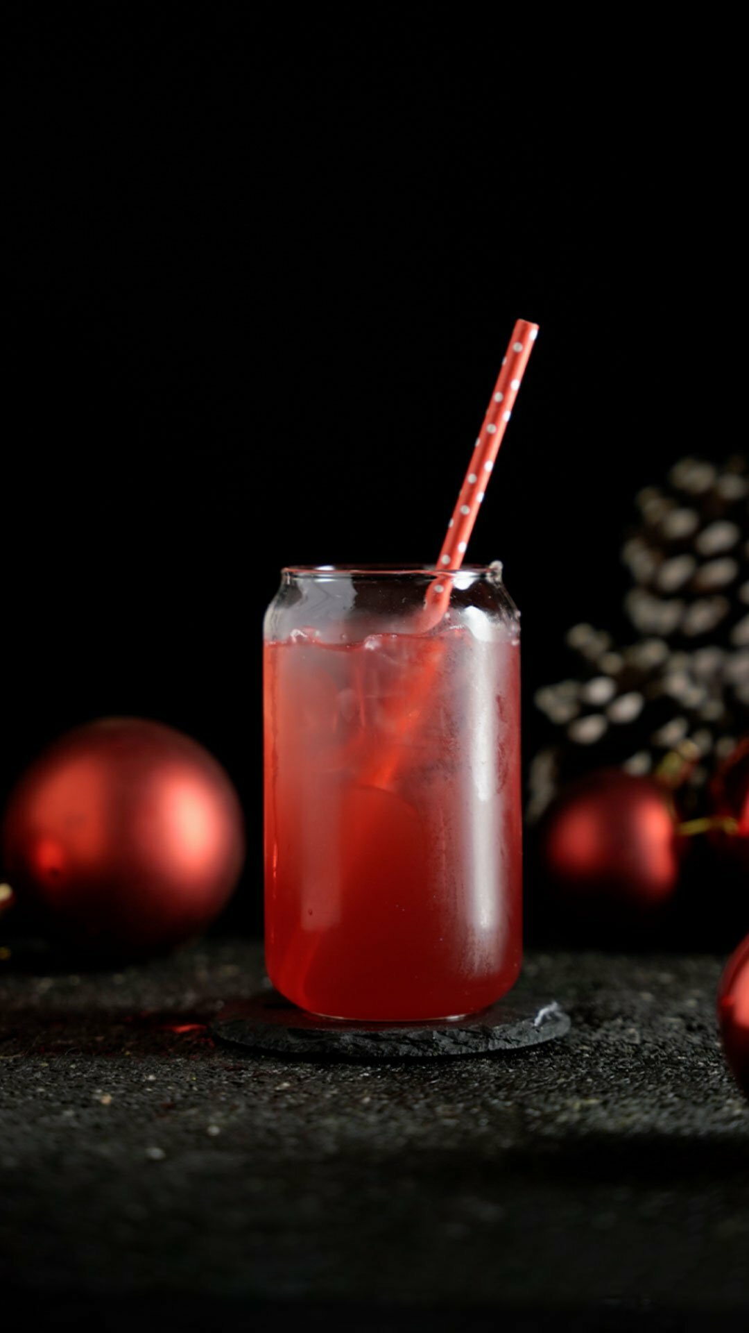 Red Cocktail in a glass jar around a Christmas background