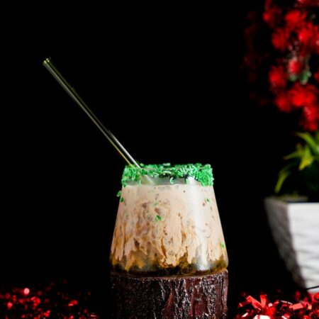 Irish Cream Pouring down in a sweet cocktail around a Christmas Background