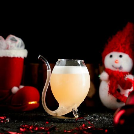 Bright Yellow Cocktail Around a Christmas Background