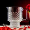 Empty Beer Mug with red and white rocks around it sitting in a dark background