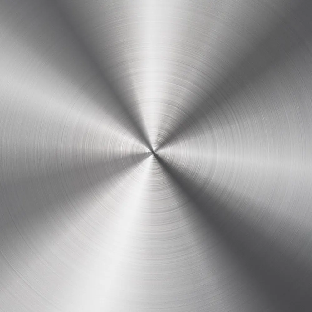 Close-up view of a brushed stainless steel surface with a radial pattern, highlighting the material’s durability and sleek appearance.