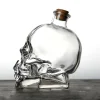 Clear glass skull-shaped Grim Reaper Bottle with a cork stopper, featuring detailed facial features, perfect for storing spirits and themed events.