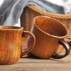 Pair of rustic wooden cocktail mugs by Skol, The Woodland Warmer, with visible grain, ideal for eco-friendly hot cocktails.