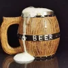 Viking-themed beer mug resembling a wooden barrel with the word ‘BEER’ written on it, overflowing with foam.