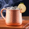 Hammered texture copper-plated stainless steel Moscow Mule mug with ice, lemon slice, and mint garnish, 500 ml capacity.