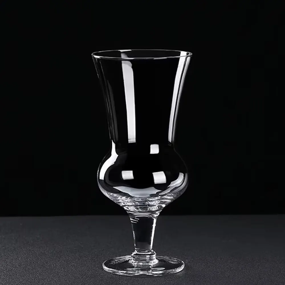 An empty 660 ml round belly cocktail glass with a flared top and narrow stem, placed against a black background.