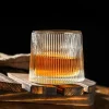 Vertico whisky glass from the Sip & Swirl Collection, featuring distinctive vertical ridges and a unique rotating base, filled with amber whisky.